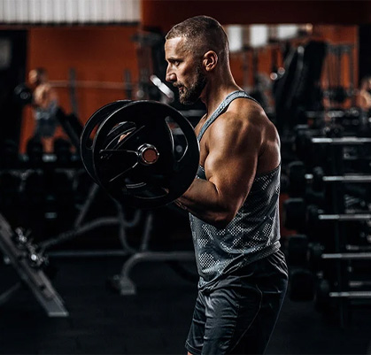 A male trainer curling weights