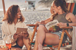 Two women smiling on the beach