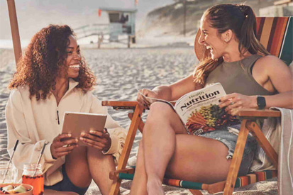 Two women smiling on the beach