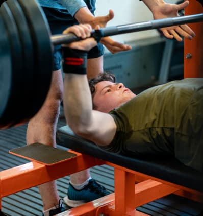 A man performs a bench press