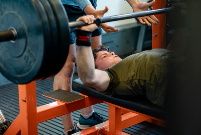 A man performs a bench press