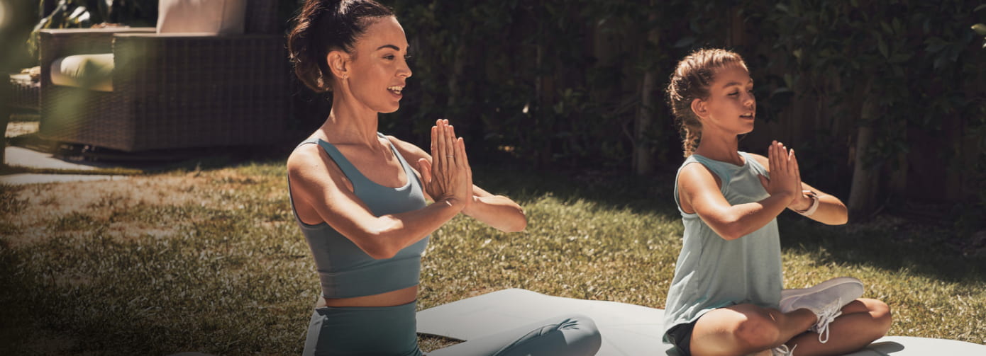 Woman and young girl doing yoga