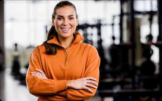 a woman smiling in the gym