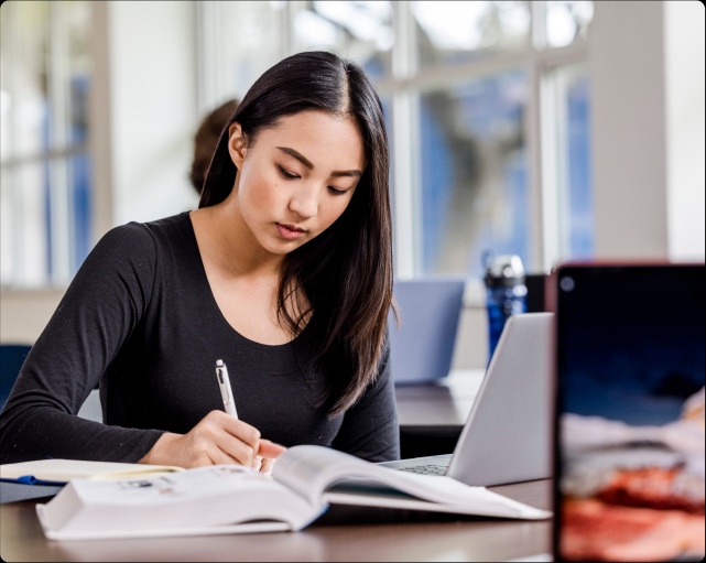 a woman studying on her laptop