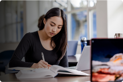 a woman studying on her laptop